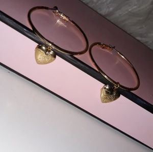 Gold hoop heart locket earrings.